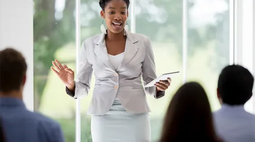 A woman practicing her business pitch.